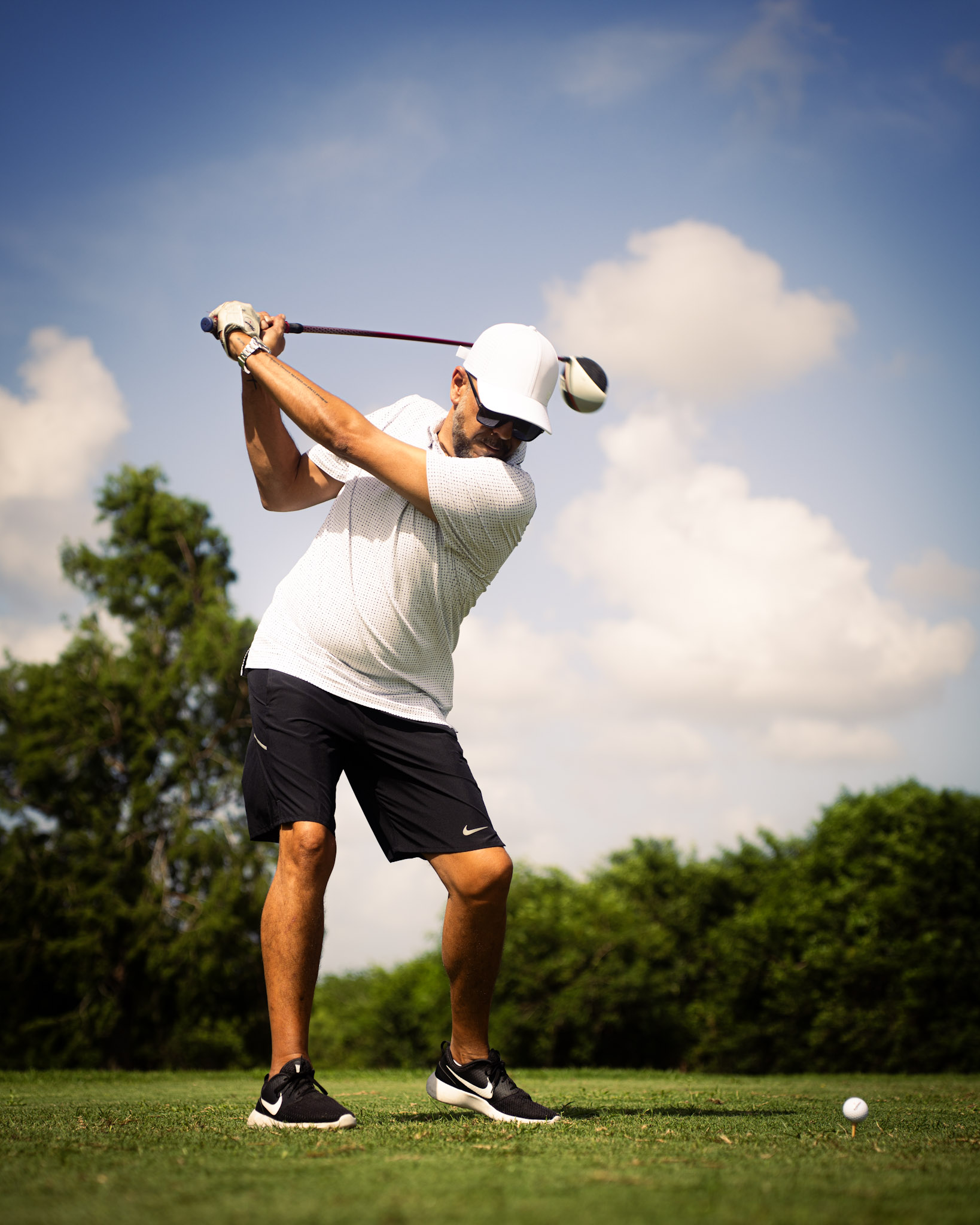 A golfer taking a swing during Nine and Dine
